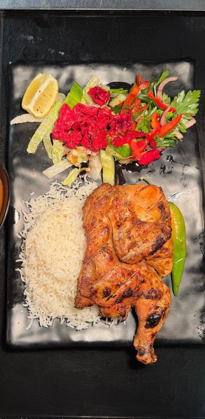 Half chicken on the grill with rice