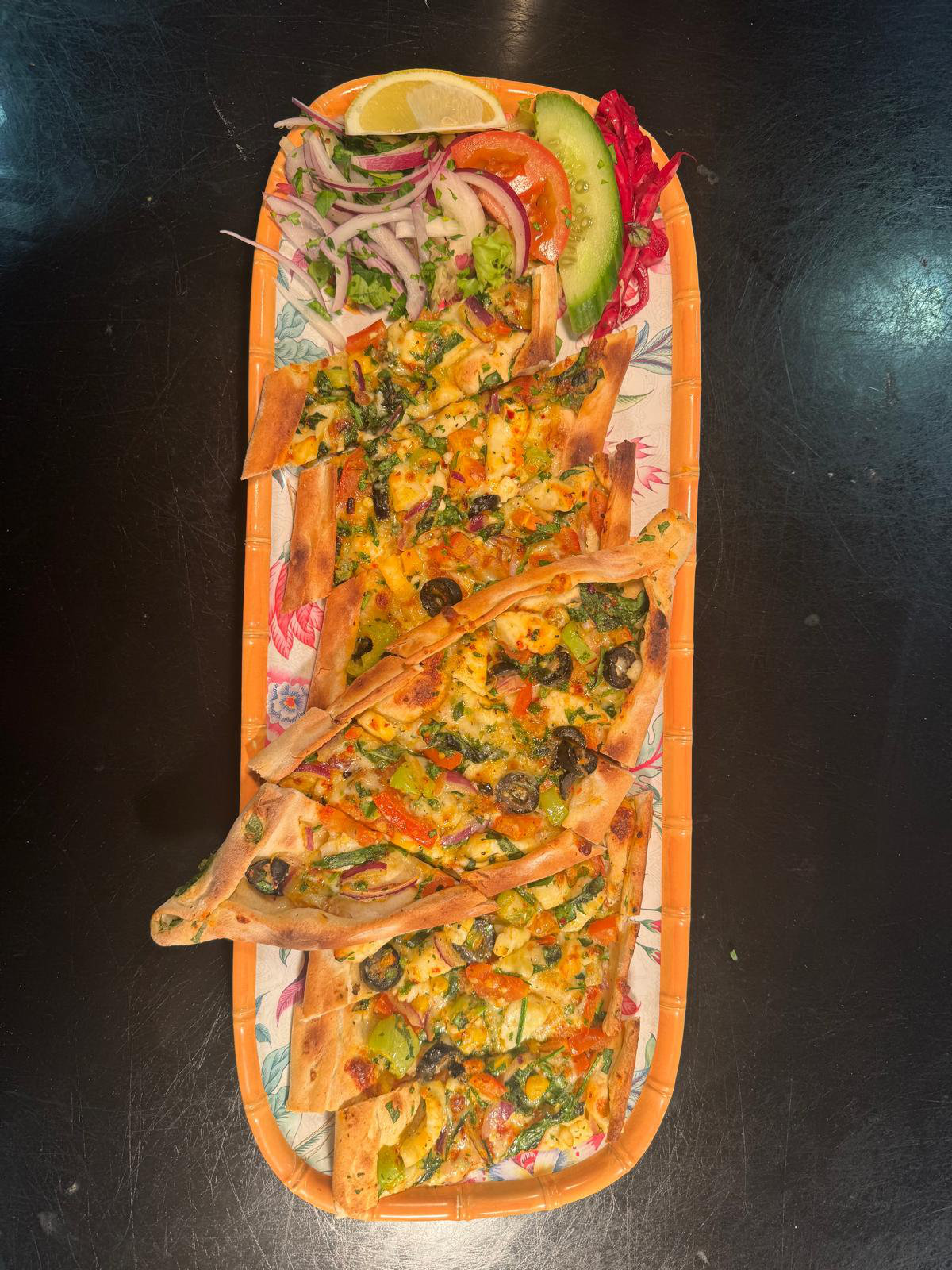 Sliced pide served with salad